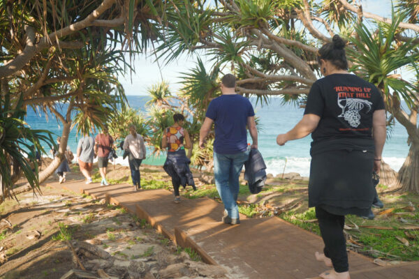 banaam alliance on country cultural experience with group on gold coast ocean near fingal heads